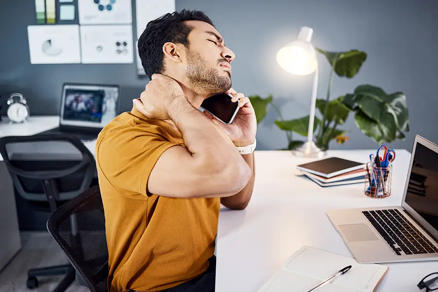 neck pain doctor st pete Photo of a man with neck pain calling doctor